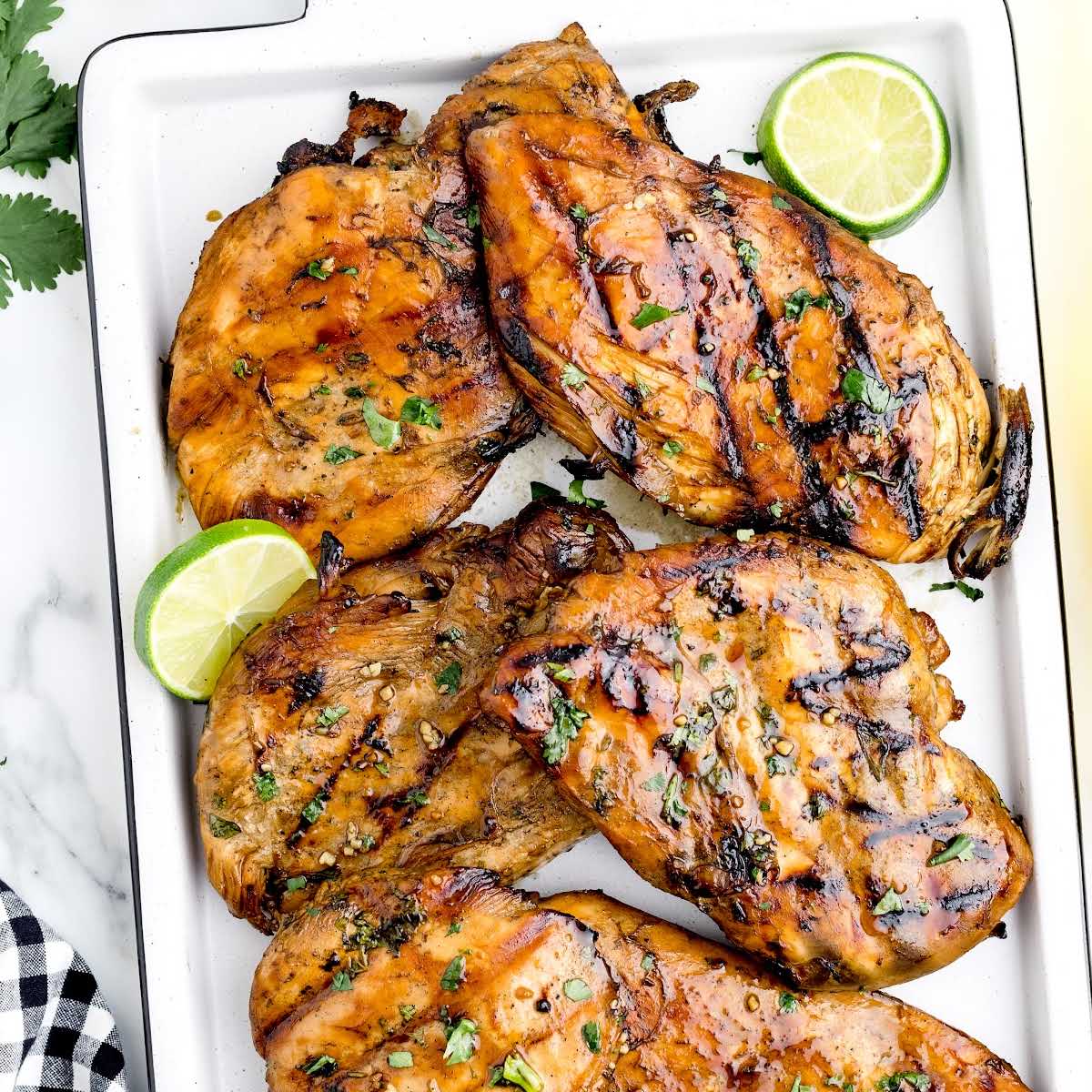 a overhead shot of Beer Marinated Chicken garnished with cilantro in a baking dish