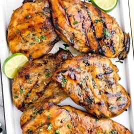a overhead shot of Beer Marinated Chicken garnished with cilantro in a baking dish
