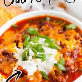 Instant Pot Chili topped with sour cream and green onion in a bowl