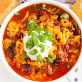 overhead shot of Instant Pot Chili topped with sour cream and green onions in a bowl