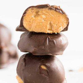 close up shot of Keto Chocolate Peanut Butter Balls stacked on top of each other