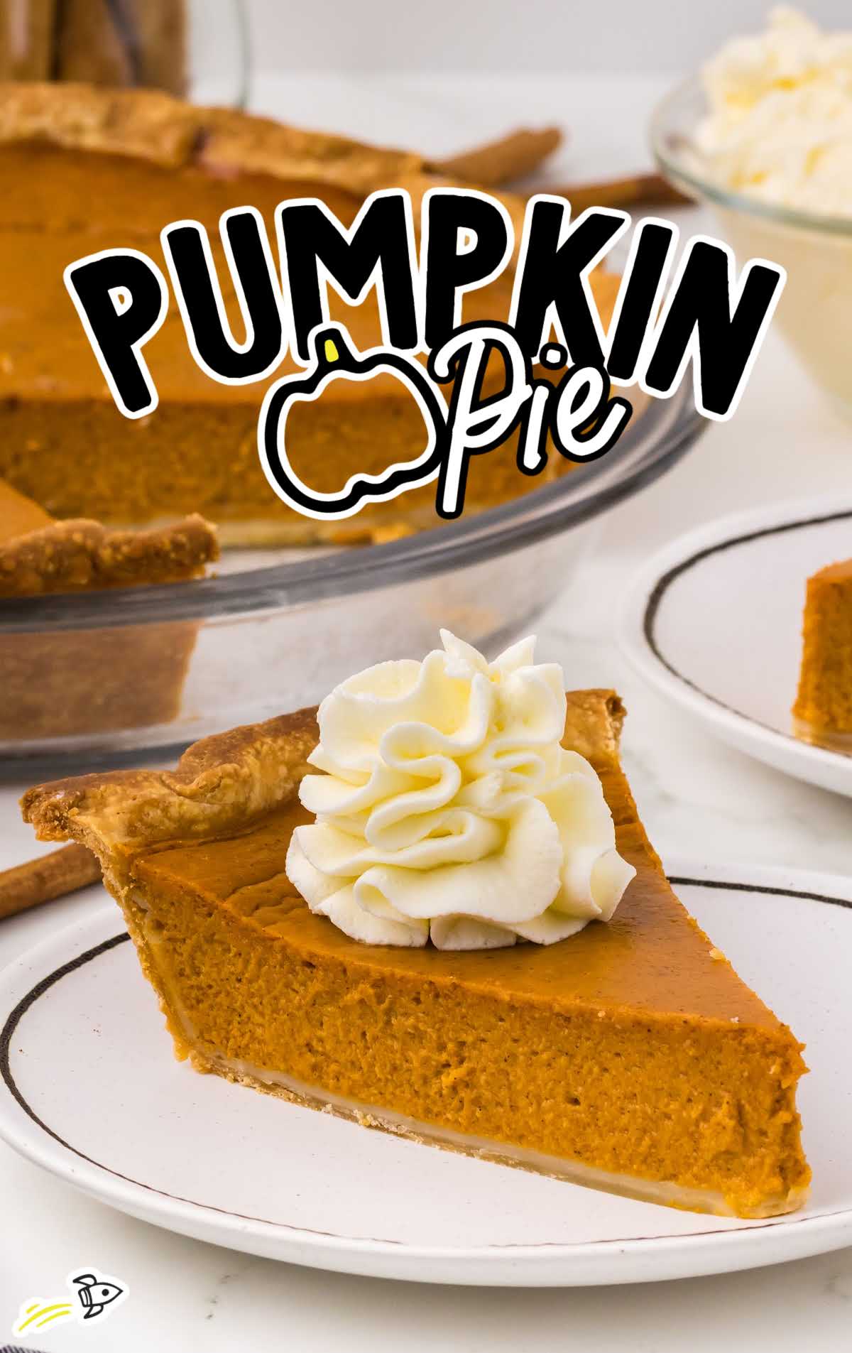 a slice of Pumpkin Pie topped with whipped cream on a plate