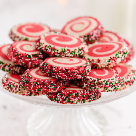 christmas pinwheels stacked on top of each other on a cake tray