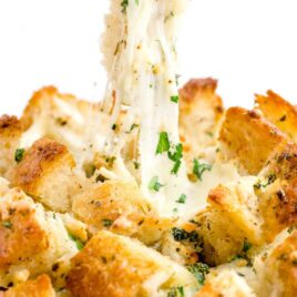close up of cheesy pull-apart bread being pulled apart