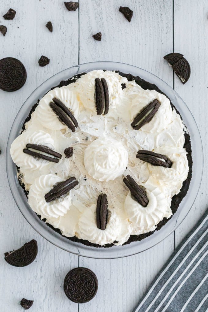 A close up of a cake on a plate, with Pie and Oreo