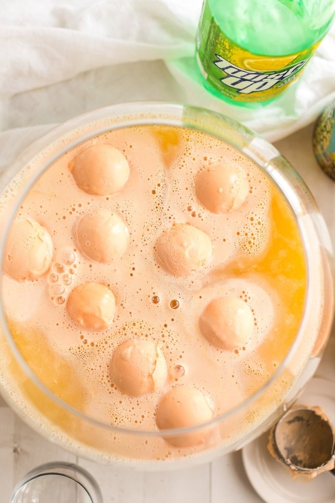 A cup of coffee on a table, with Sherbet and Punch