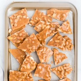 overhead shot of pieces of Cashew Brittle on a baking tray
