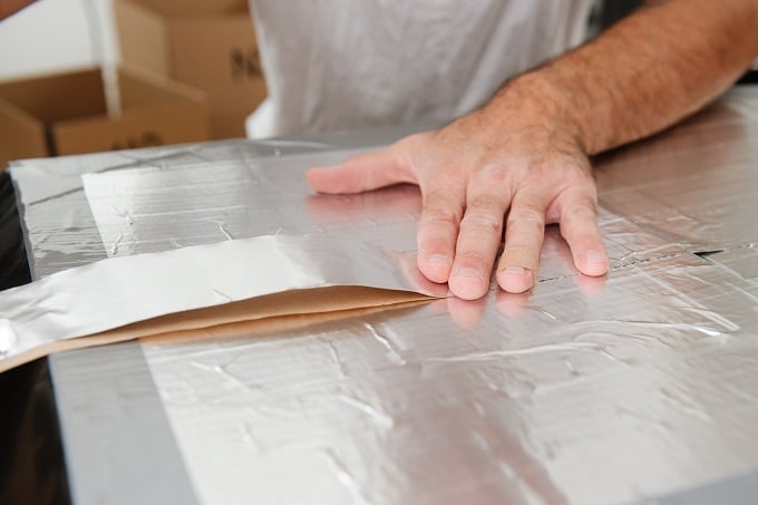 A person cutting a piece of paper