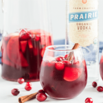 A bottle of wine and a bowl of fruit, with Sangria