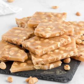 close up shot of pieces of peanut brittle piled on top of each other