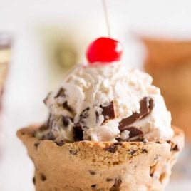 close up shot of Chocolate Chip Cookie Cups with ice cream and a cherry on top