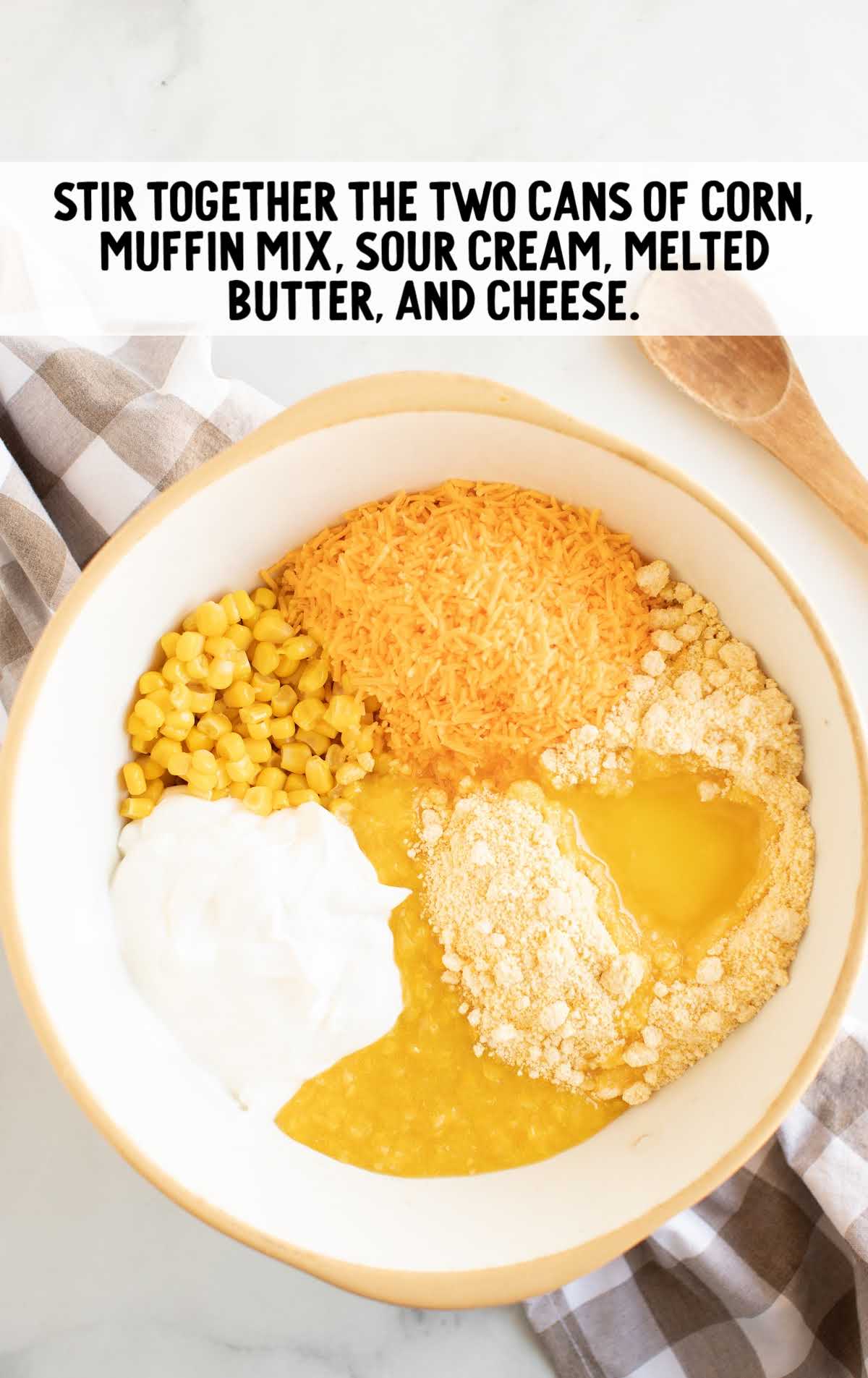 corn, corn muffin mix, sour cream, melted butter, and cheese in a bowl