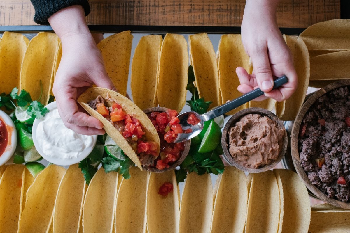 A close up of food on a table, with Taco and Tomato