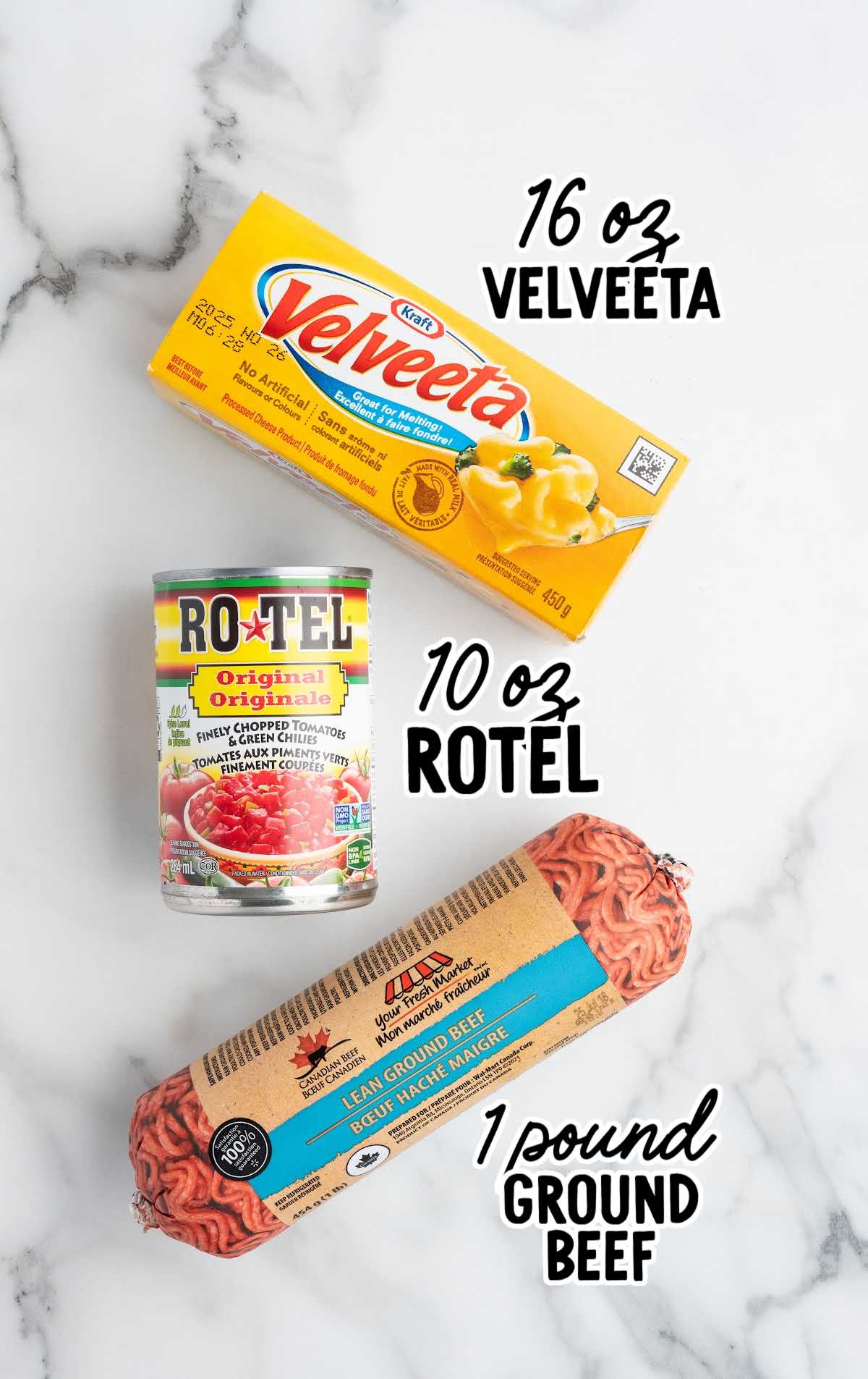 Flat lay of 3 ingredients for Rotel dip: block of Velveeta cheese, can of Rotel tomatoes, and a package of ground beef.