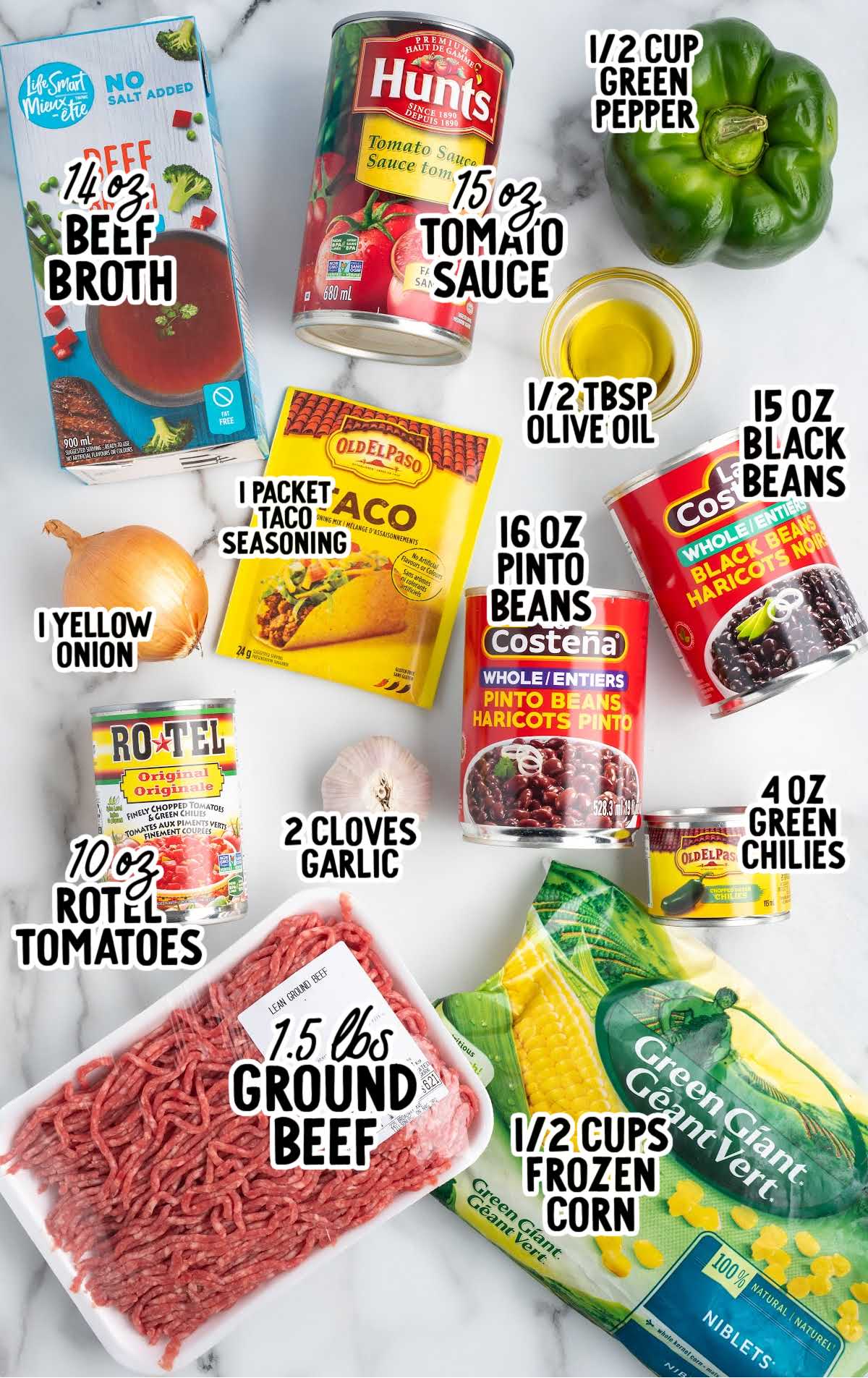 Flat lay of taco soup ingredients including ground beef, beans, corn, green chilies, Rotel, broth, seasonings, and fresh produce.