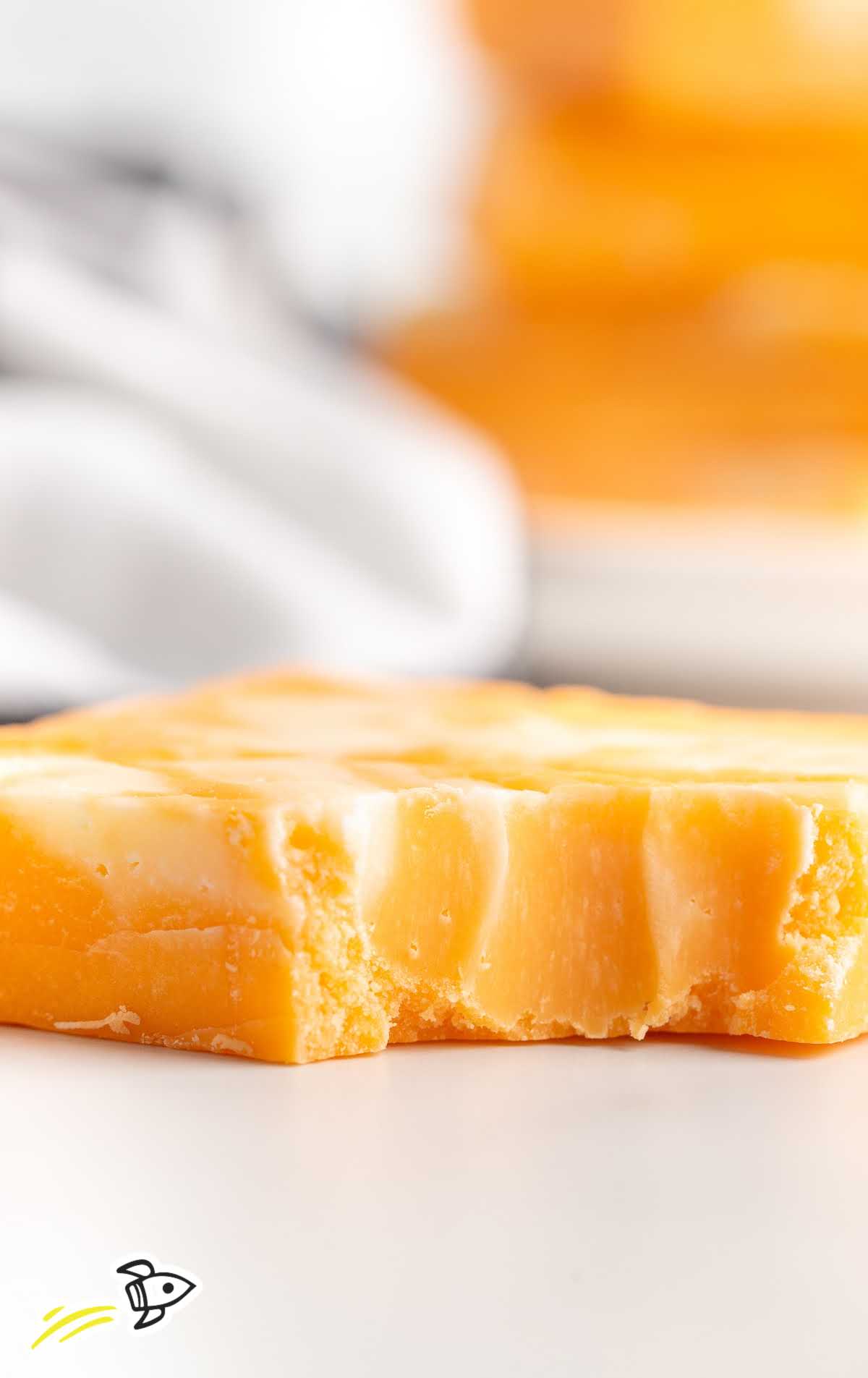 a close up shot of Creamsicle Fudge with a bite taken out of it