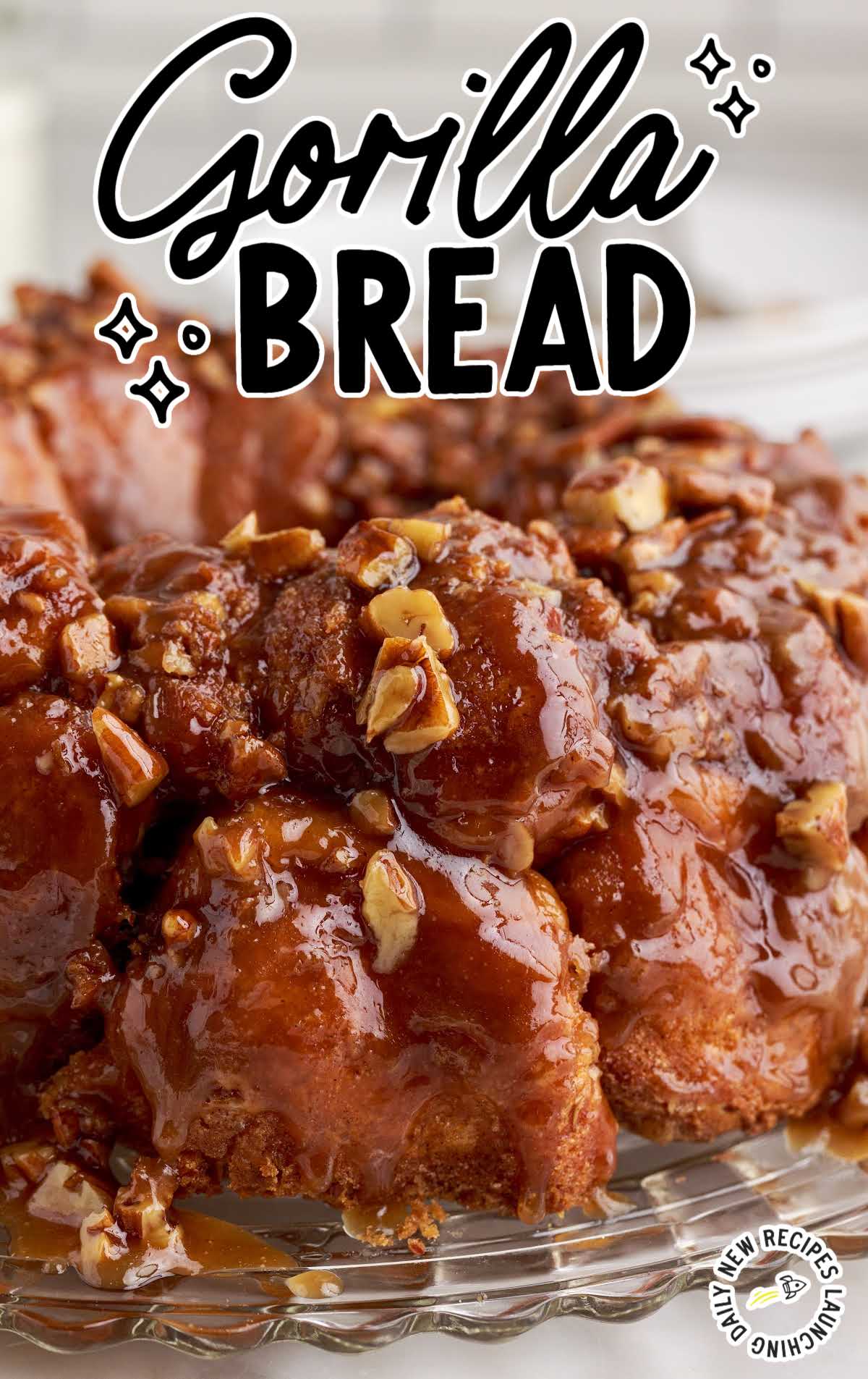 close up shot of Bread topped with glaze and pecans 