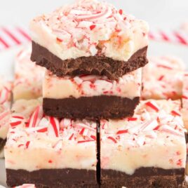 A close up shot of Layered Peppermint Fudge stacked on top of each other with one having a bite taken out of it