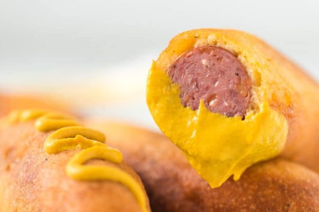 A close up of food on a plate, with Laser and Corn dog