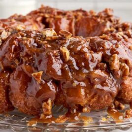 close up shot of Bread topped with glaze and pecans