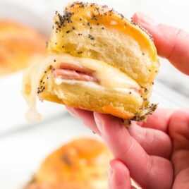 close up shot of someone holding a Ham and Cheese Sliders