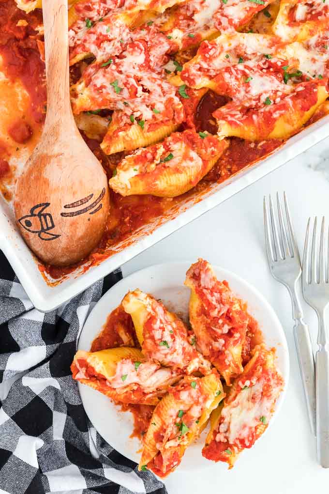 stuffed shells in casserole dish and on a plate