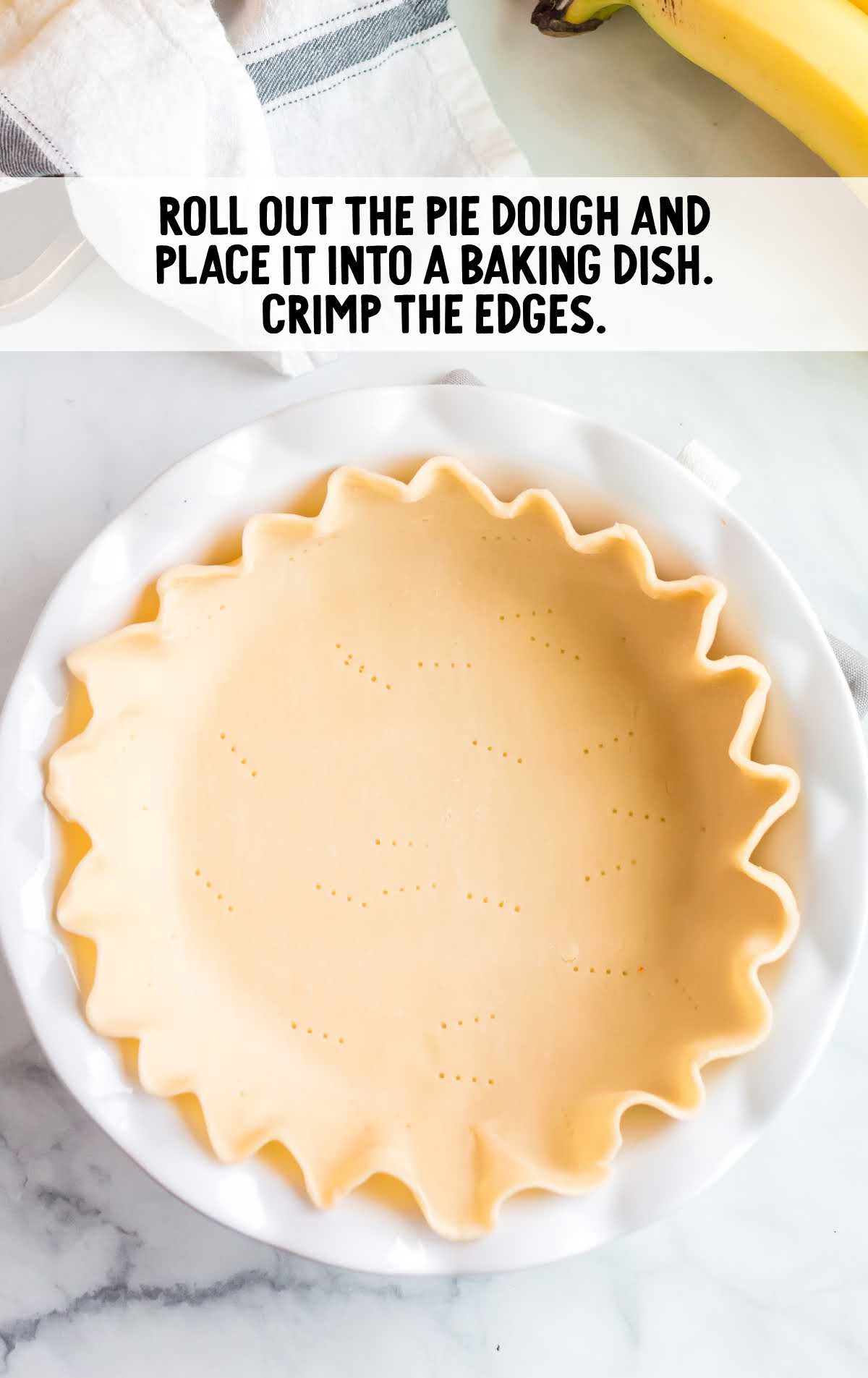 pie dough shaped into a pie form in a baking dish