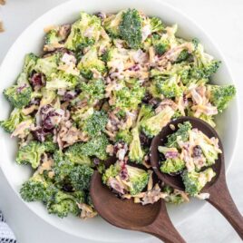 overhead shot of Broccoli Salad with wooden spoon in a bowl