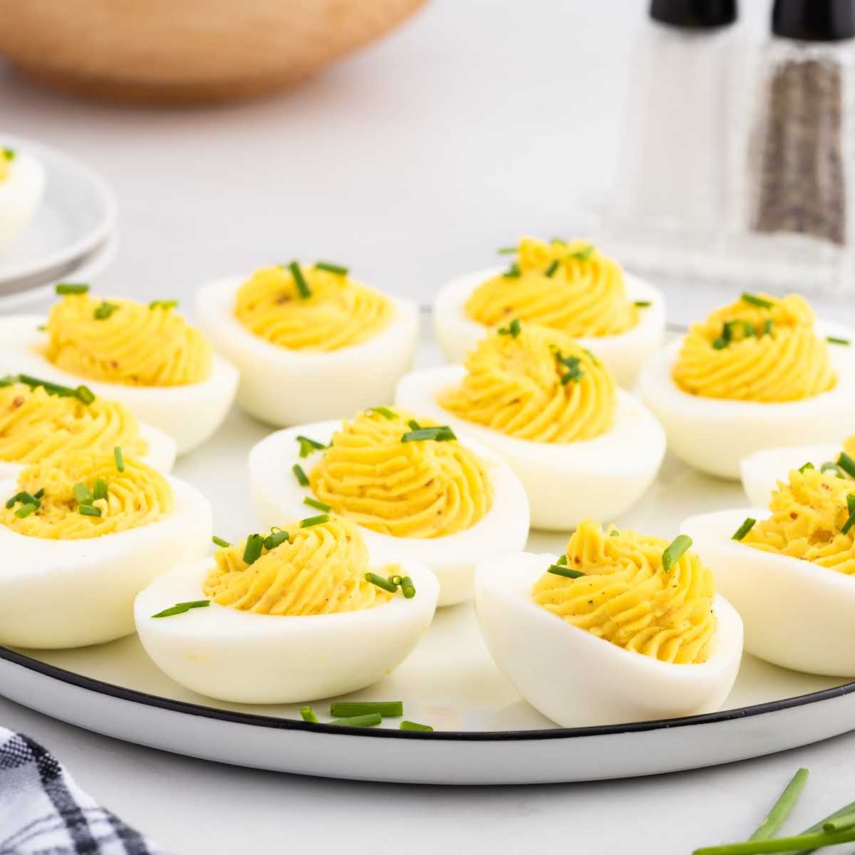 a plate of Deviled Eggs garnished with chives