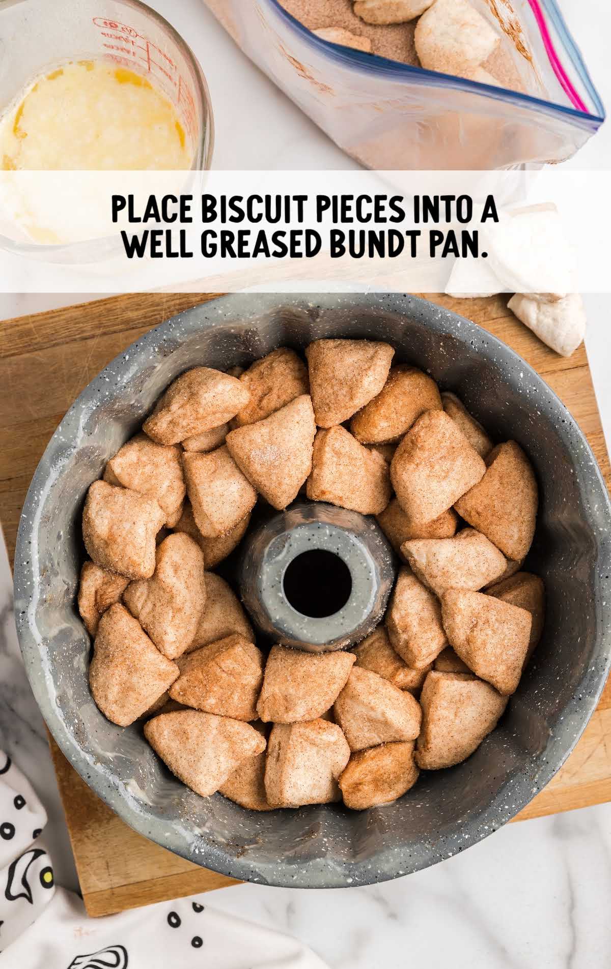 biscuits pieces placed into a greased bundt pan