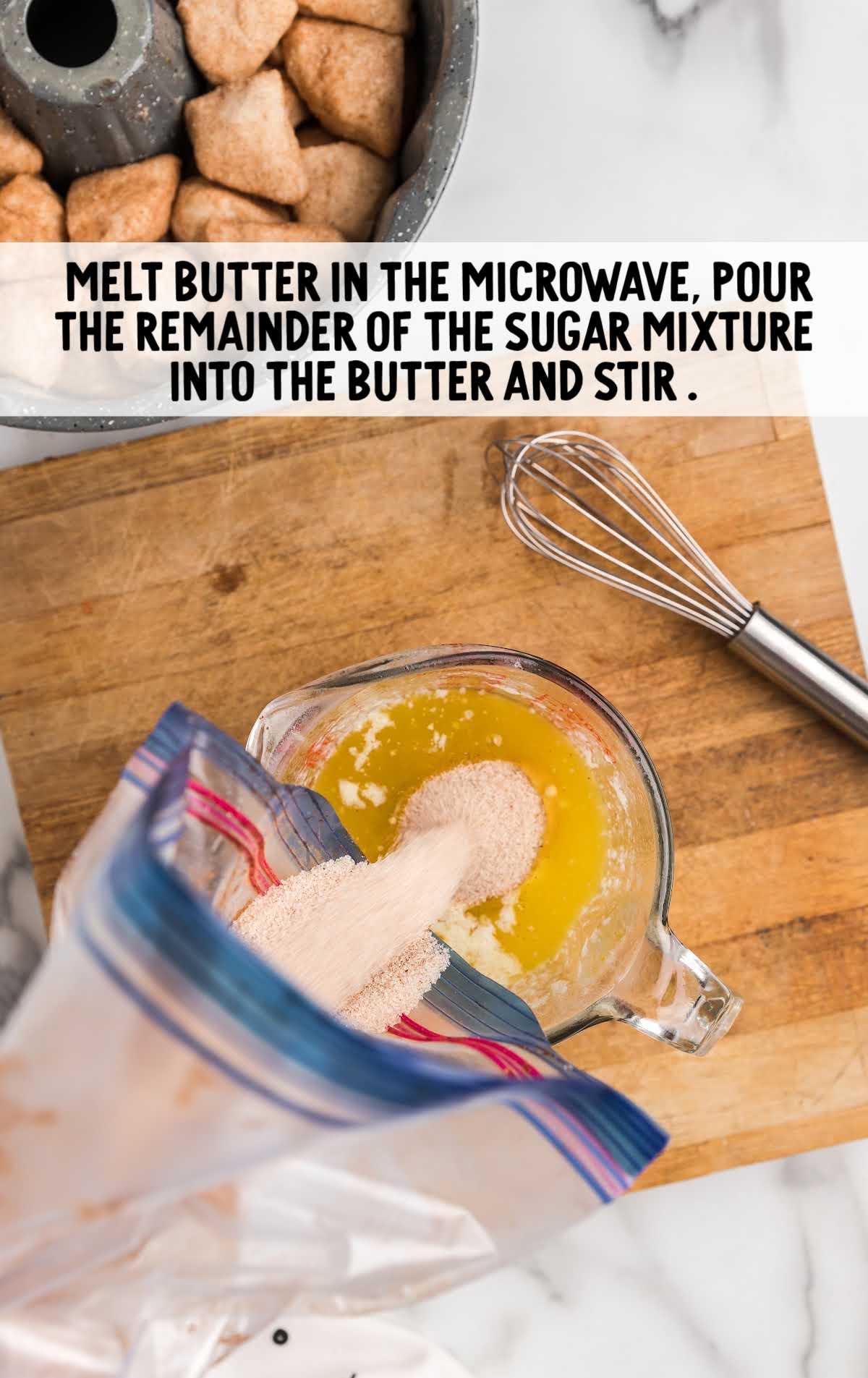 cinnamon mixture placed into a measuring cup of melted butter