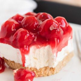 close up shot of a slice of No Bake Cherry Cheesecake on a plate