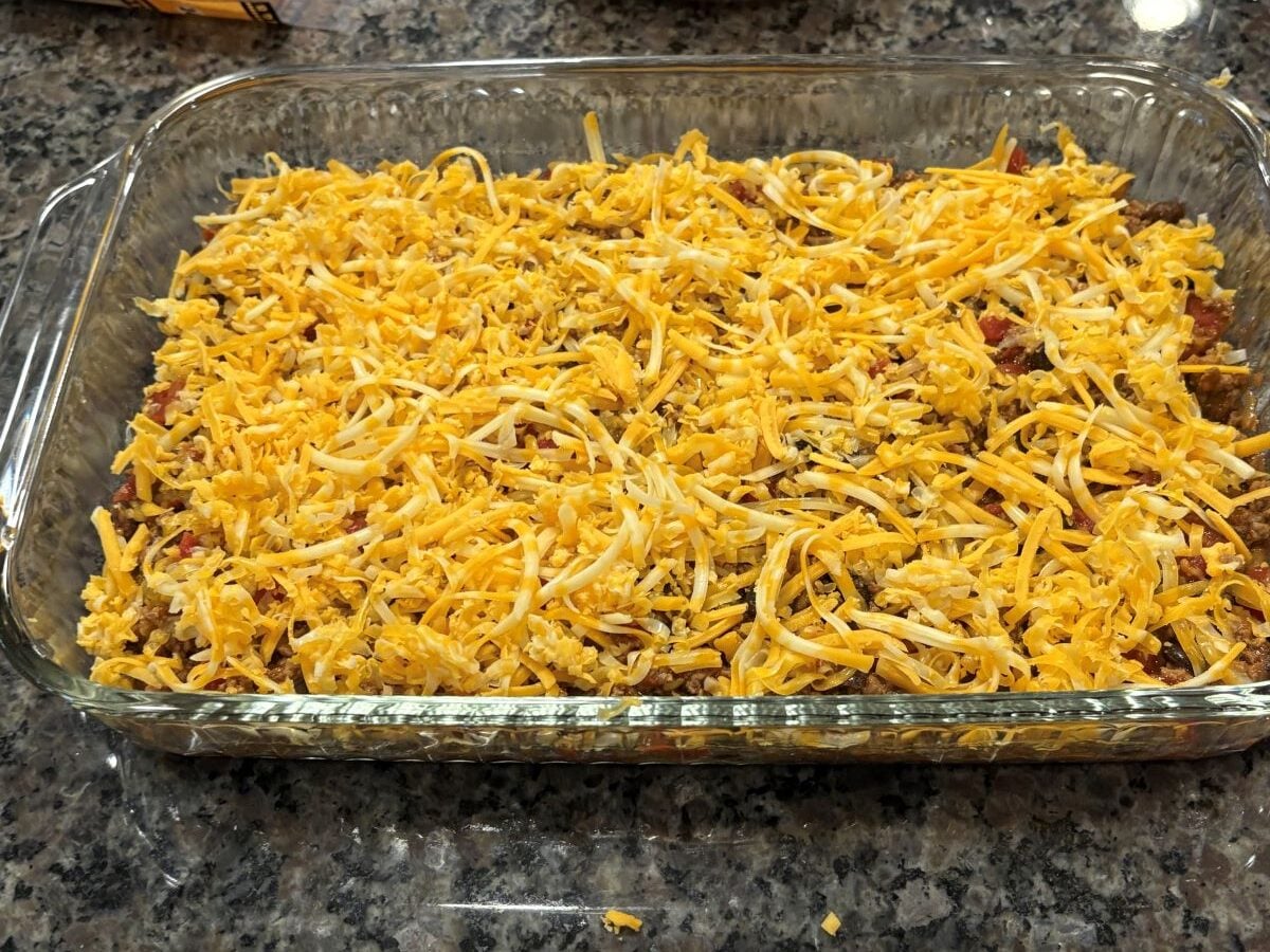 shredded cheese placed on top in a baking dish