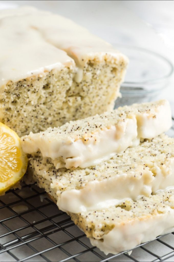 close up of lemon poppy seed bread with slices and a lemon