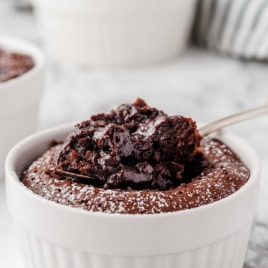 close up shot of Carnival Cruise Line Lava Cake in a ramekin with a scoop being taken out of it with a spoon