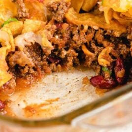 close up shot of Frito Pie in a baking dish with a slice taken out