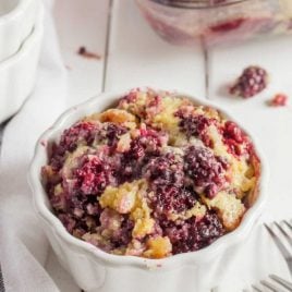 a serving of blackberry cobbler in a white bowl