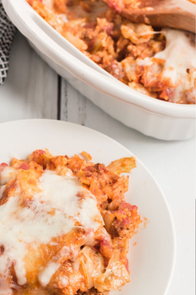 cabbage roll casserole on plate next to casserole dish