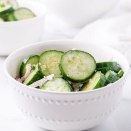 A bowl of food with broccoli, with Cucumber and Salad