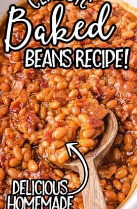 overhead shot of baked beans in a white baking dish being picked up with a wooden spoon