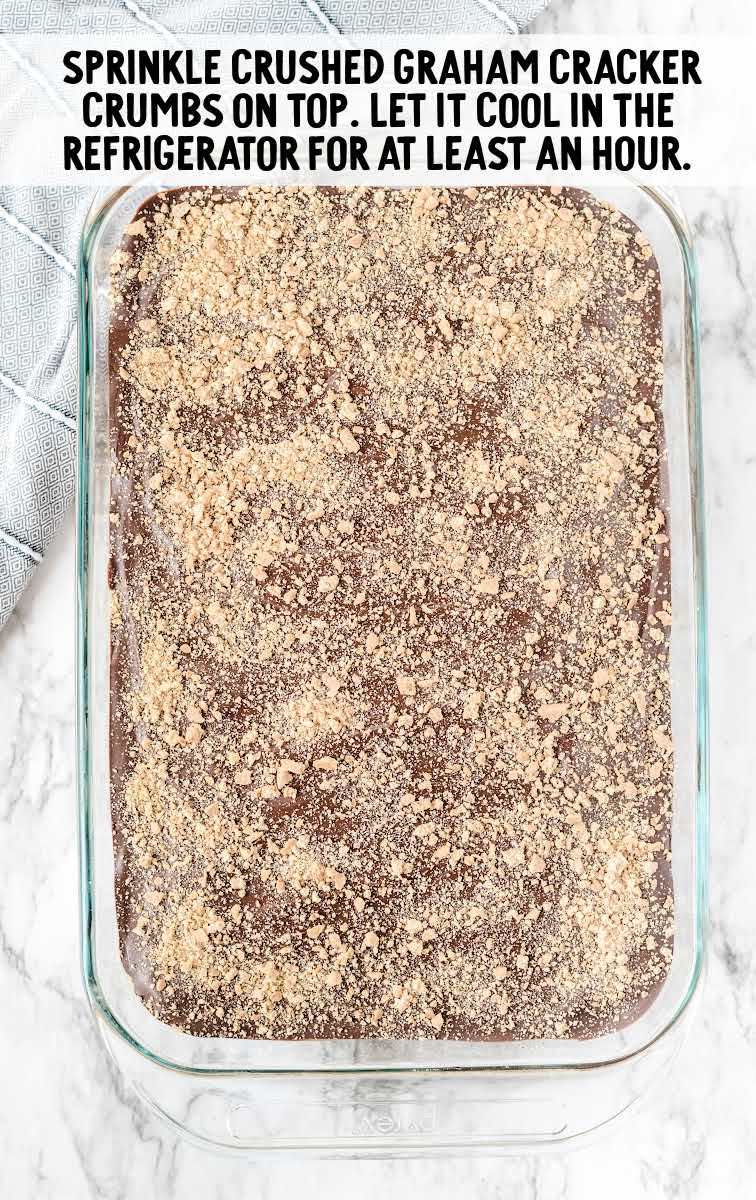 crushed graham crackers sprinkled on top of the chocolate in a baking dish