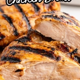 Text overlay “Juiciest Grilled Chicken Breast” with sliced chicken on a cutting board and a small dish of marinade in the corner.
