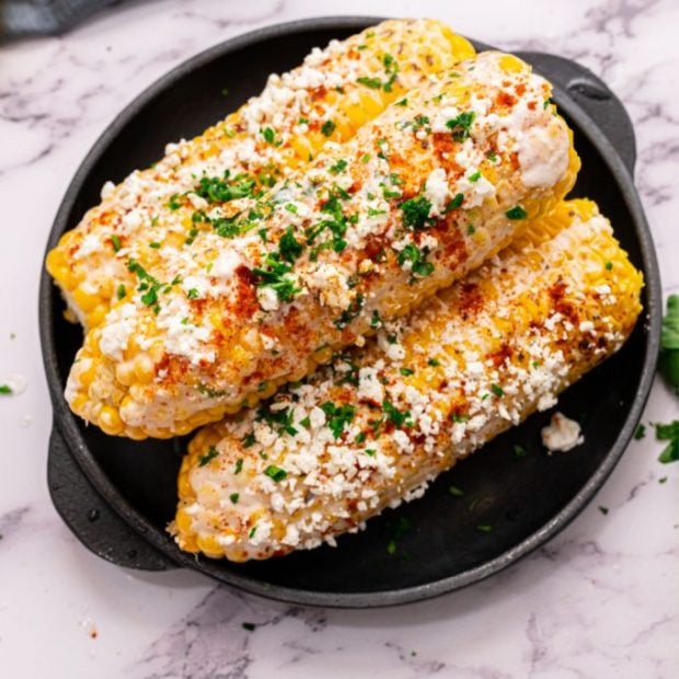 A plate of food, with Corn on the cob