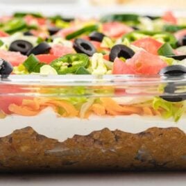 close up shot of Layered Taco Salad in a baking dish