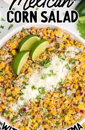 close up overhead shot of Mexican corn salad garnished with parsley then topped with Cotija cheese and lime slices