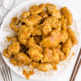 close up overhead shot of a plate of Orange Chicken served over a bed of white rice