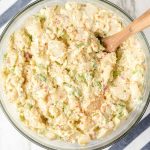 close up overhead shot of a bowl of Potato Salad with a large spoon