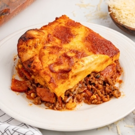 A slice of upside down pizza on a white plate.