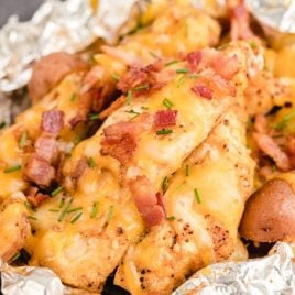 Chicken Foil Packet topped with pieces of cheese and bacon