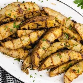 close up shot of a plate of Grilled Potatoes garnished with parsley